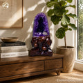 Natural green rind amethyst geode on cabinet display